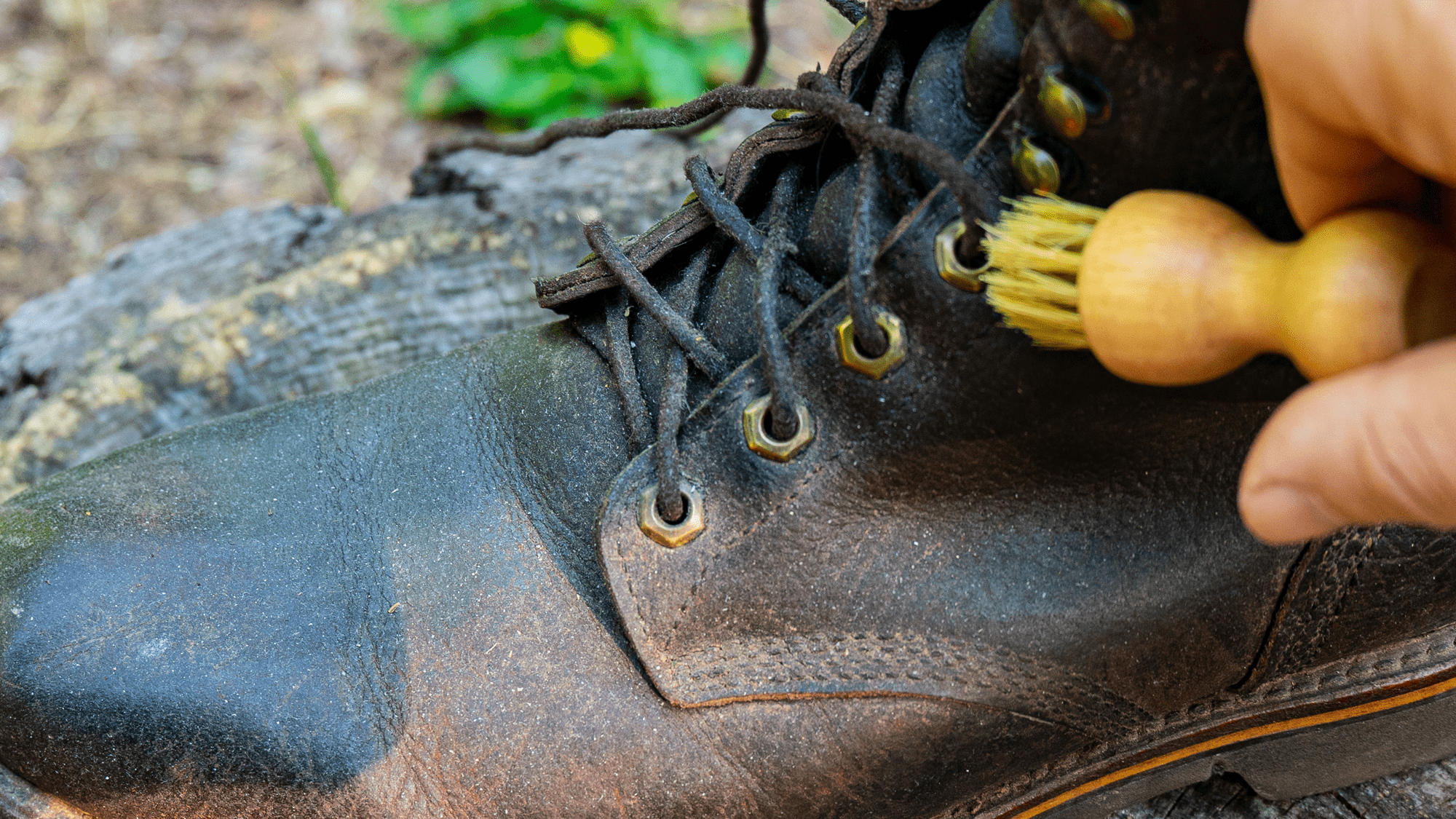 Cleaning a boot with dauber palm brush