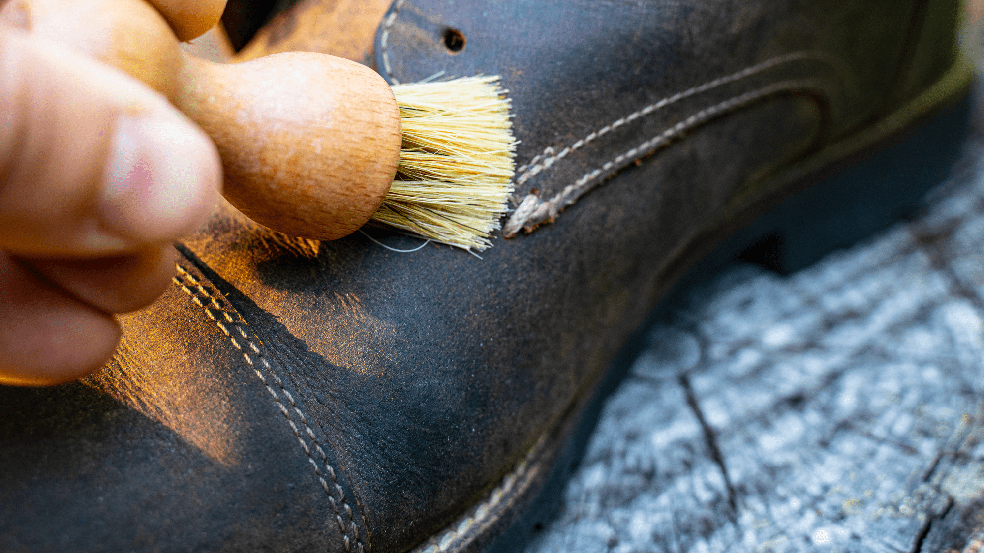 Cleaning suede shoes with a dauber palm brush