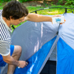 Max waxing a tent with fabric waterprooofer